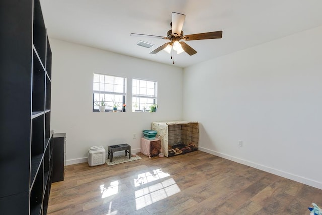 interior space featuring hardwood / wood-style floors and ceiling fan