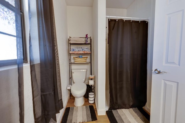 bathroom featuring toilet and walk in shower