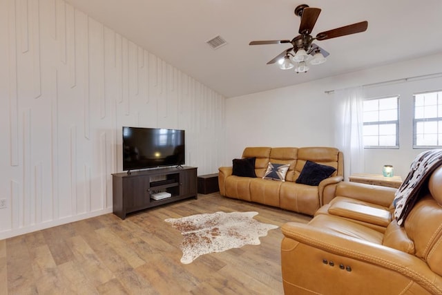 living room with ceiling fan and light hardwood / wood-style floors