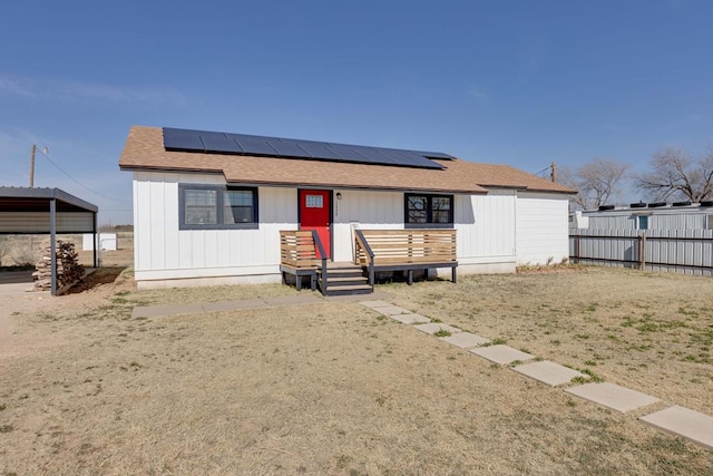 view of front of property featuring solar panels