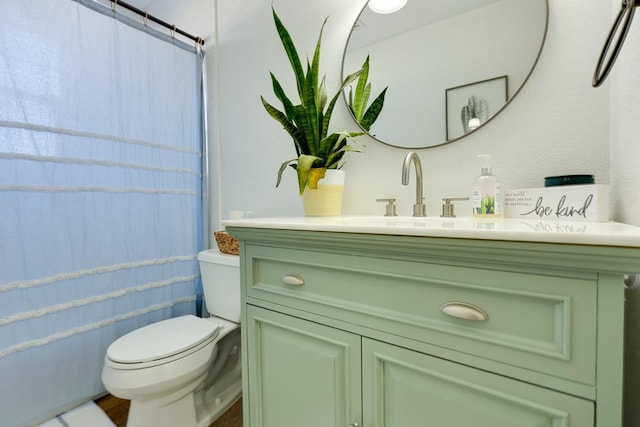 bathroom with vanity, toilet, and walk in shower