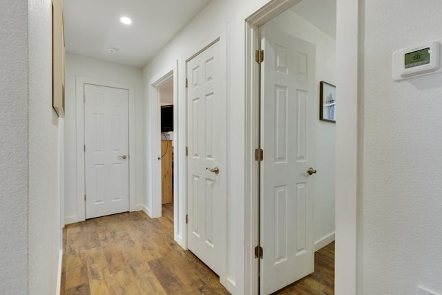 corridor with light wood-type flooring