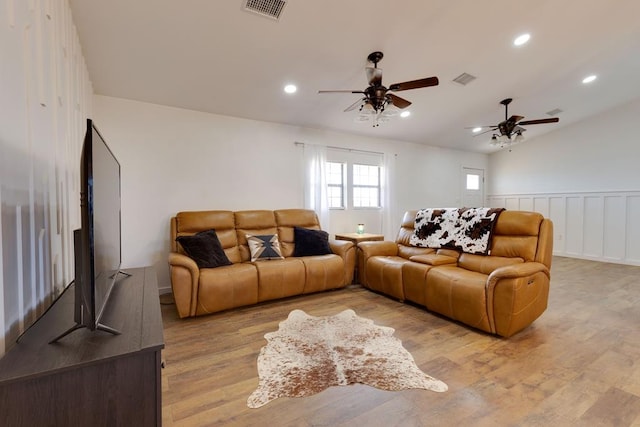 living room with vaulted ceiling, ceiling fan, and light hardwood / wood-style floors