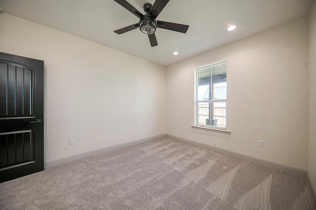 empty room with light colored carpet and ceiling fan