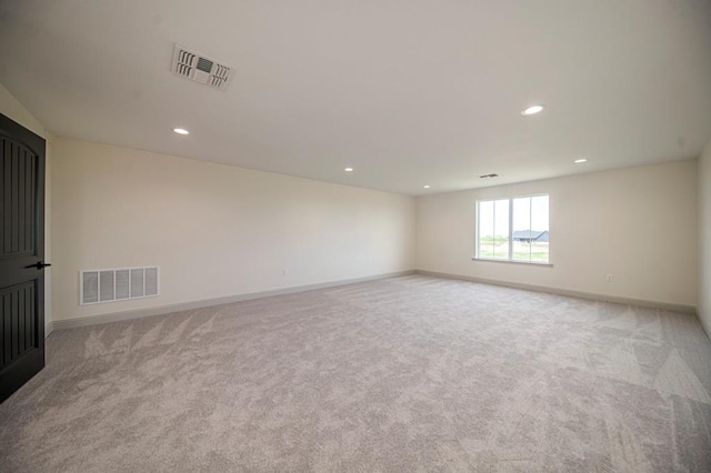 spare room featuring light colored carpet