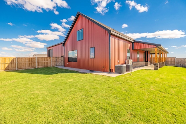 rear view of property with a lawn and central AC unit