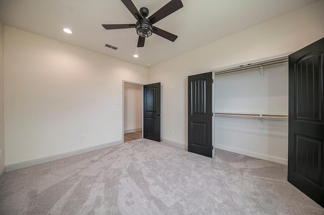 unfurnished bedroom with light carpet, a closet, and ceiling fan