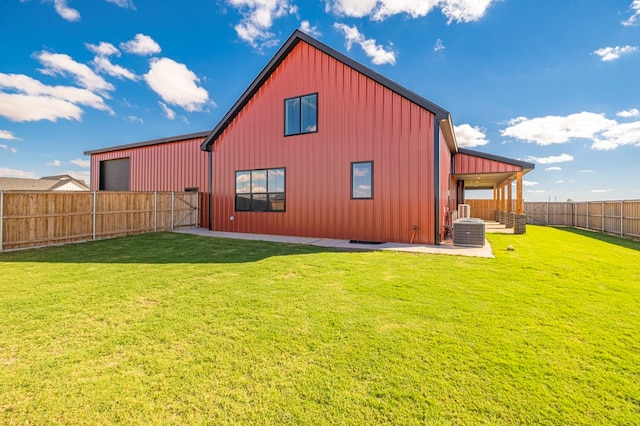 back of house with a lawn and central air condition unit