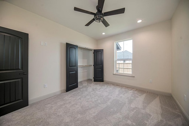 unfurnished bedroom featuring light colored carpet and ceiling fan