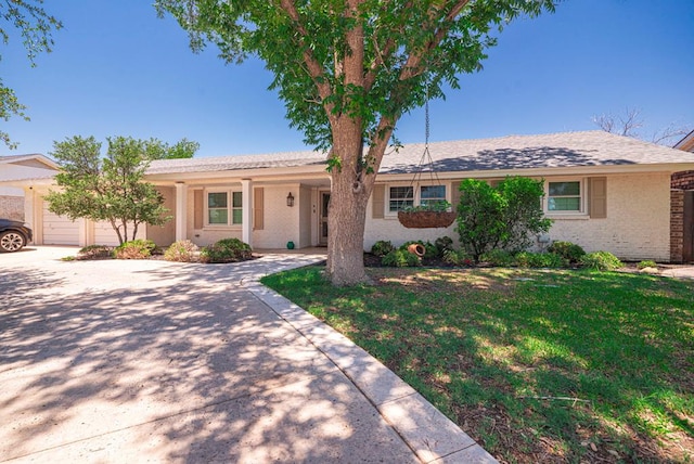 1602 Cimmaron Dr, Midland, TX 79705 - single story home with a front lawn, brick siding, an attached garage, and concrete driveway