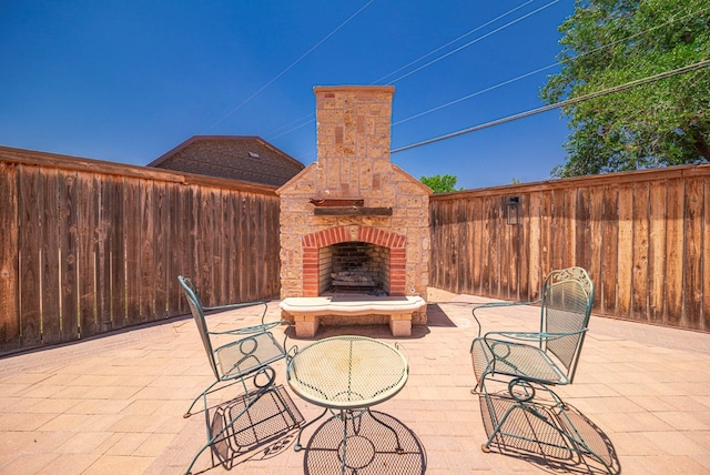 1602 Cimmaron Dr, Midland, TX 79705 - view of patio / terrace featuring an outdoor brick fireplace