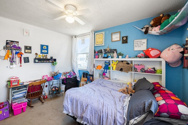 carpeted bedroom with a textured ceiling and a ceiling fan