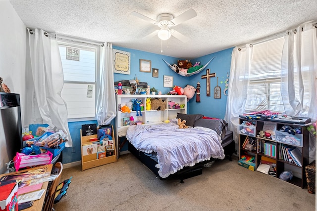 bedroom with baseboards, a textured ceiling, ceiling fan, and carpet