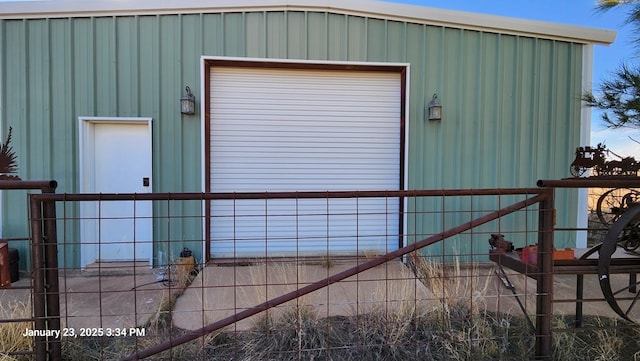 exterior space featuring a garage and an outdoor structure