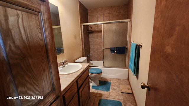 full bathroom featuring toilet, vanity, shower / bath combination with glass door, and tile patterned flooring