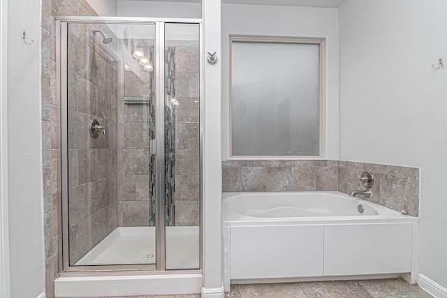 bathroom with a stall shower and a bath