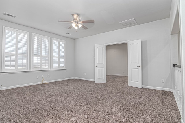 interior space with carpet floors, baseboards, and visible vents