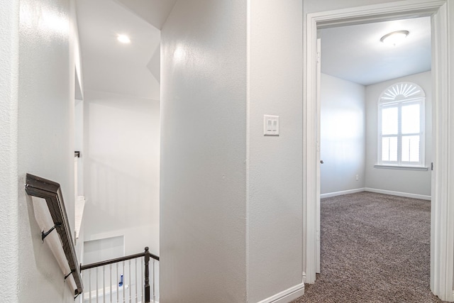 hall with carpet floors and baseboards