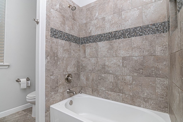 bathroom with tile patterned flooring, baseboards, shower / bath combination, and toilet