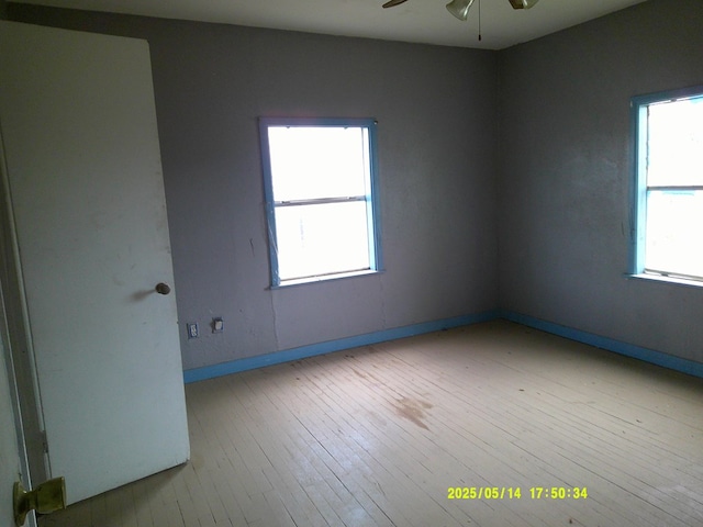 1100 Nolan St, Big Spring, TX 79720 - unfurnished room featuring ceiling fan, hardwood / wood-style flooring, baseboards, and healthy amount of natural light