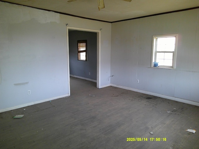 1100 Nolan St, Big Spring, TX 79720 - unfurnished room featuring crown molding, healthy amount of natural light, wood finished floors, and baseboards