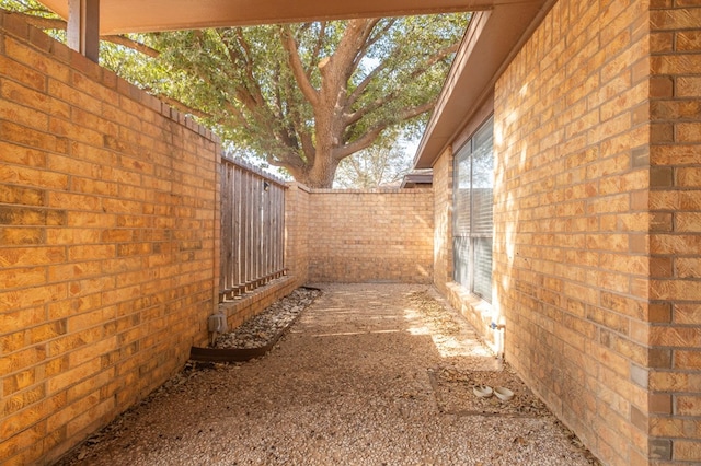 view of home's exterior featuring brick siding and fence private yard