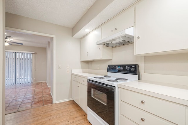 kitchen featuring range with electric cooktop, white cabinets, light countertops, light wood-type flooring, and under cabinet range hood