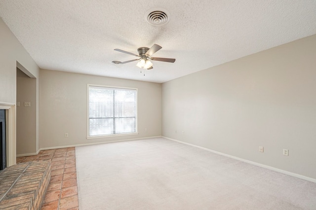 unfurnished living room featuring a glass covered fireplace, visible vents, ceiling fan, and baseboards