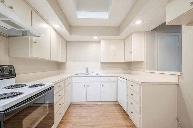 kitchen with under cabinet range hood, black / electric stove, light countertops, and a sink