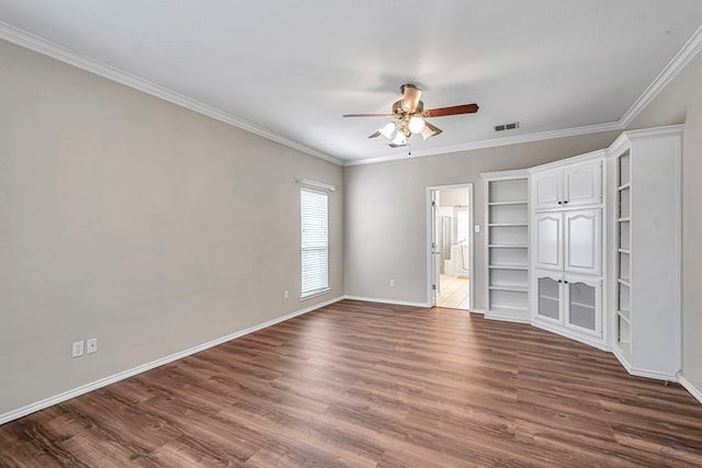 unfurnished bedroom featuring visible vents, dark wood-type flooring, and ornamental molding