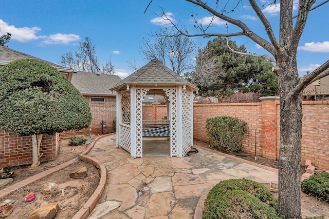 view of patio / terrace featuring fence and a gazebo