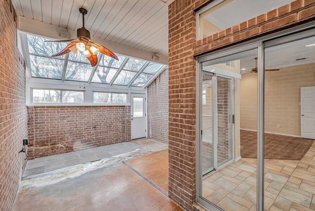 unfurnished sunroom with ceiling fan