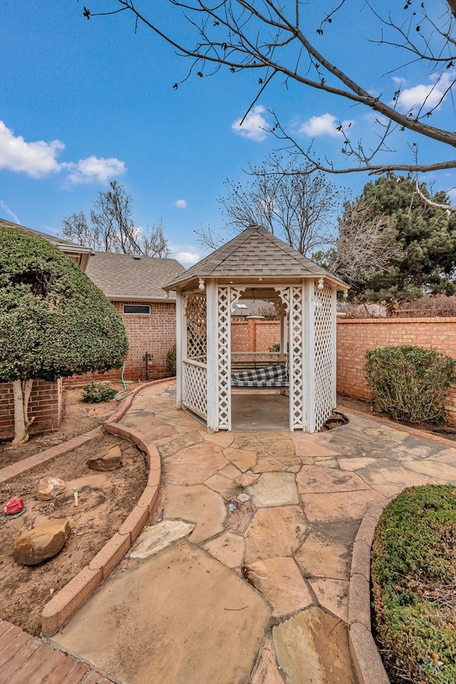 view of patio / terrace with fence and a gazebo