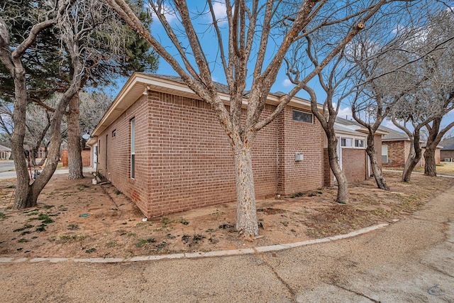 view of side of home featuring brick siding