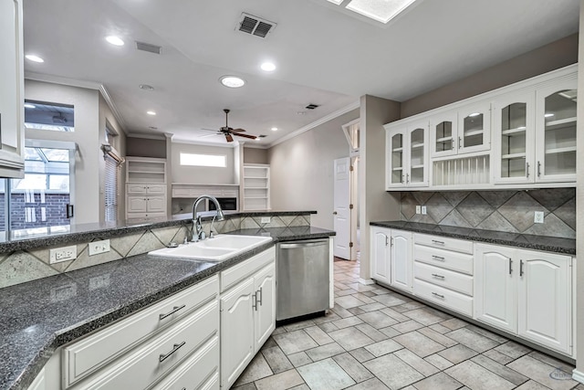 kitchen with a sink, visible vents, white cabinets, stainless steel dishwasher, and glass insert cabinets