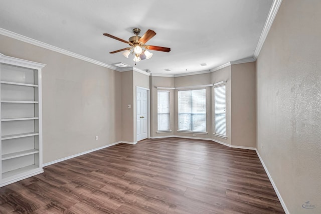 spare room with dark wood-type flooring, crown molding, baseboards, and ceiling fan