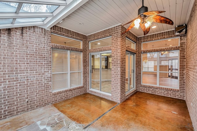 unfurnished sunroom with a skylight and ceiling fan