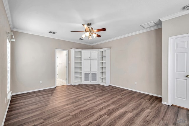 unfurnished bedroom featuring dark wood-style floors, visible vents, and crown molding