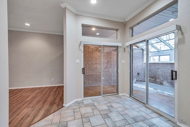 doorway featuring ornamental molding, stone tile flooring, and baseboards