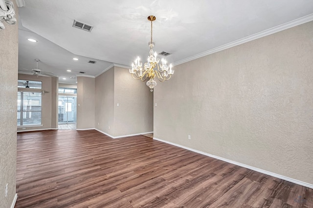 empty room with dark wood-style flooring, visible vents, and a textured wall