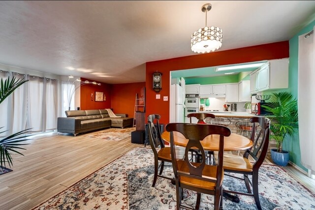 600 Liddon Unit 78, Midland, TX 79705 - dining room with light wood finished floors and a chandelier