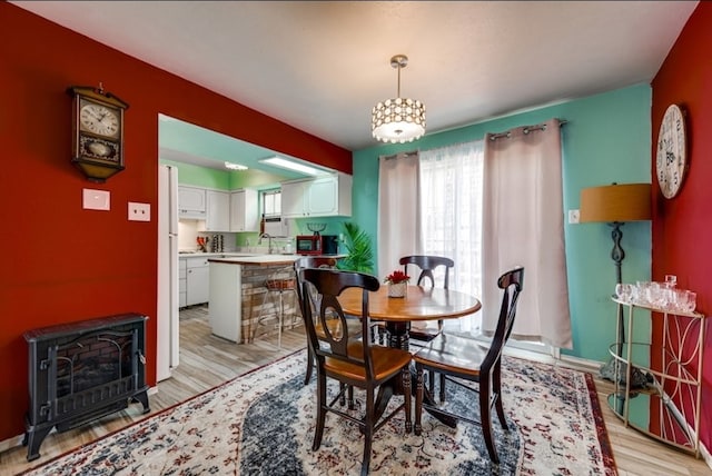 600 Liddon Unit 78, Midland, TX 79705 - dining space with a wood stove and light wood-type flooring