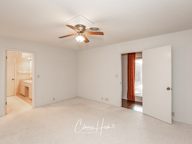 1209 W Pecan Ave, Midland, TX 79705 - unfurnished bedroom featuring connected bathroom, a ceiling fan, and carpet floors