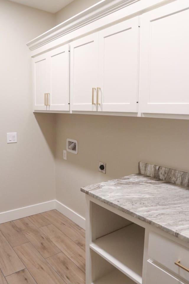 3624 Yorkshire Dr, Odessa, TX 79765 - laundry room featuring washer hookup, hookup for an electric dryer, cabinets, and light wood-type flooring