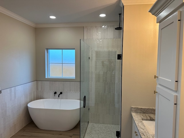 3624 Yorkshire Dr, Odessa, TX 79765 - bathroom featuring vanity, crown molding, wood-type flooring, tile walls, and independent shower and bath