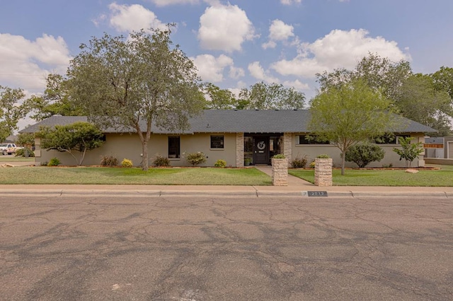 ranch-style house with a front lawn