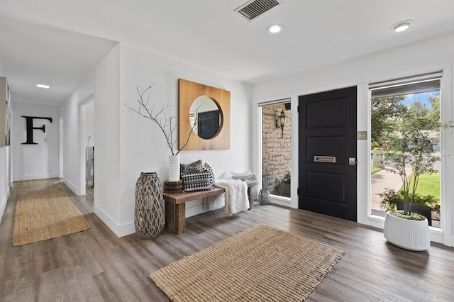 entryway with baseboards, visible vents, wood finished floors, and recessed lighting