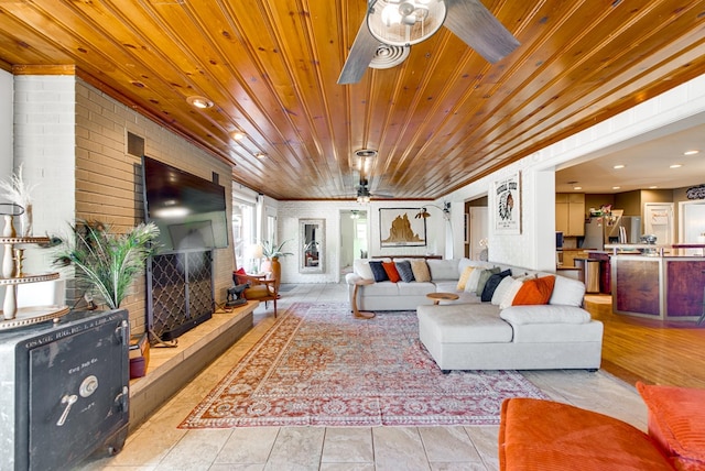 tiled living room featuring brick wall, ceiling fan, and wood ceiling