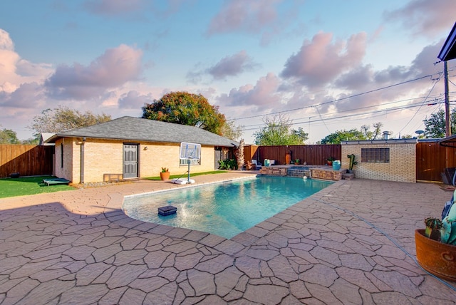 view of swimming pool with an in ground hot tub and a patio area