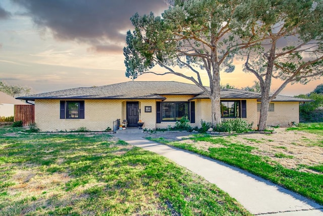 ranch-style home featuring a yard